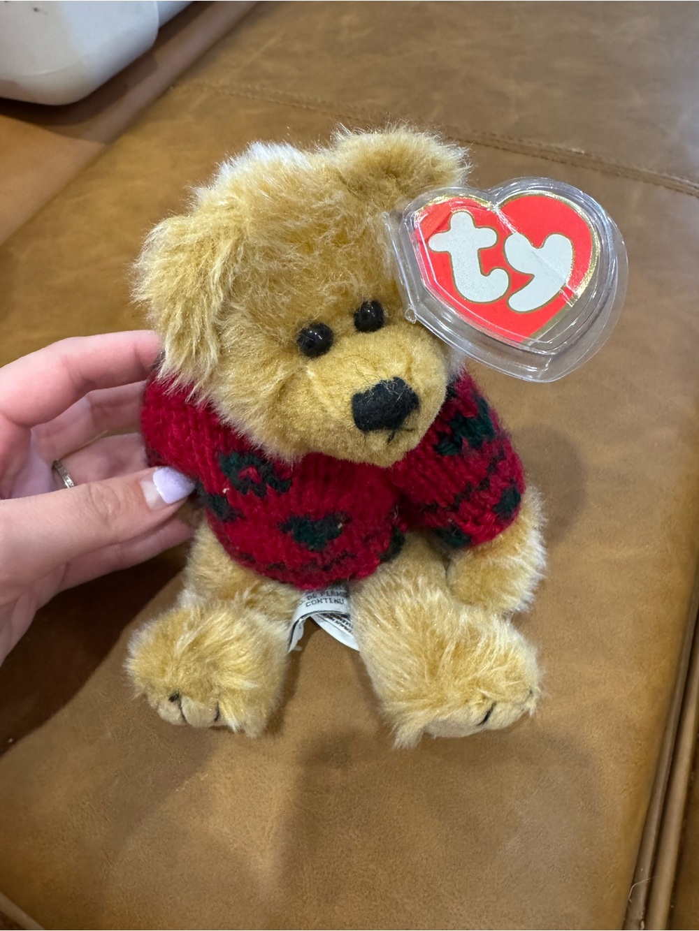 A Ty Attic Treasures 'Bearkhardt' teddy bear plush with a holiday sweater.
